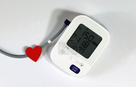 Red Heart and Blood Pressure Monitor Heart Disease Diagnostic Concept. Digital blood pressure monitoring device and heart on a white background.