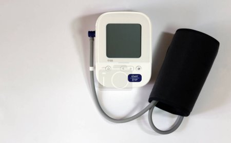 Blood pressure monitor medical diagnostic device. Digital blood pressure monitoring device on a white background.