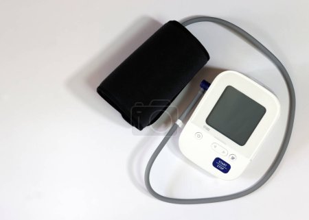 Blood pressure monitor medical diagnostic device. Digital blood pressure monitoring device on a white background.