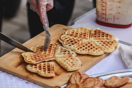 Téléchargez les photos : Preparing waffle or waffles, dish made from leavened butter or dough that is cooked between two plates that are patterned to give a characteristic size, shape, and surface impression - en image libre de droit