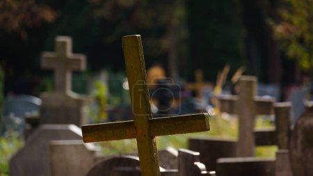 Téléchargez les photos : CEMETERY - Old wooden crucifix and tombstones at burial site of the dead - en image libre de droit