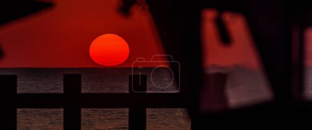 Foto de SUNSET BY THE SEA - El sol de la tarde se esconde detrás del horizonte - Imagen libre de derechos