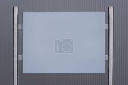 Photo for INFRASTRUCTURE - A empty board on metal posts against  background of the wall - Royalty Free Image