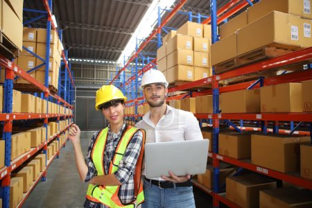 Photo for Portrait of worker in warehouse, they happy and working at The Warehouse. Storehouse area, Shipment.  warehouse worker unloading pallet goods in warehouse - Royalty Free Image