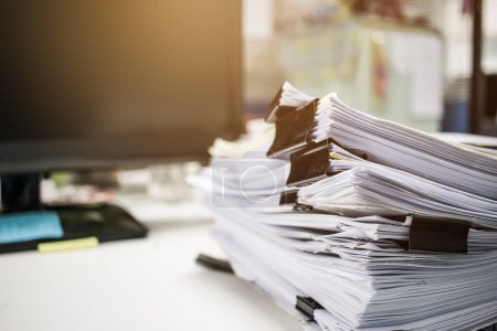 Businessman hands searching information in Stacks of paper files on work desk office, business report papers or piles of unfinished documents achieves with clips on offices indoor, Business concept