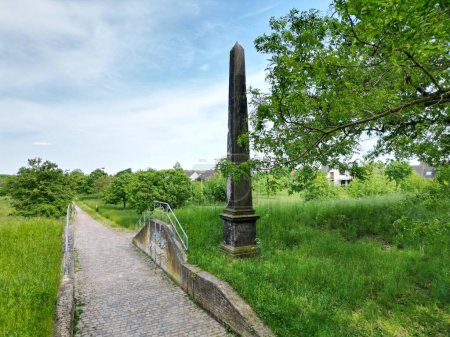 Photo for Obelisk on the long-distance cycle path in Dessau on the Elbe embankment - Royalty Free Image