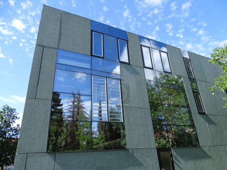 Photo for Trees reflected in the coated windows of a modern house in Dessau, Germany - Royalty Free Image
