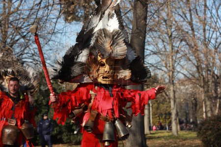 Téléchargez les photos : Sofia, Bulgaria - January 8, 2023: Masquerade festival "Surva" in Sofia, Bulgaria. People with mask called Kukeri dance and perform to scare the evil spirits. - en image libre de droit