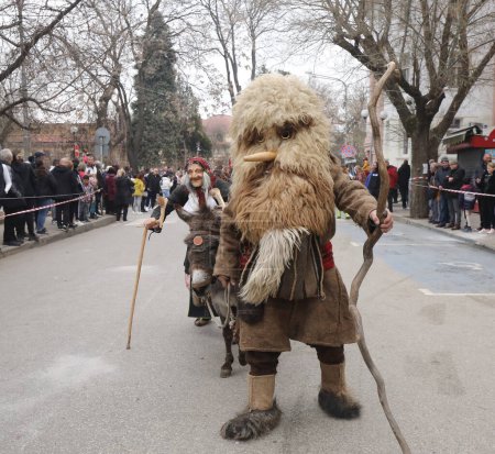 Foto de Kyustendil, Bulgaria - 10 de febrero de 2024: Primer festival de máscaras "Djamala" en Kyustendil, Bulgaria. La gente con máscara llamada Kukeri baila y actúa para asustar a los espíritus malignos. - Imagen libre de derechos
