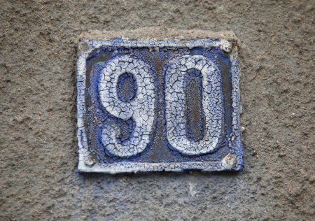 Vintage square ceramic street number plate with number. Close up, brand.