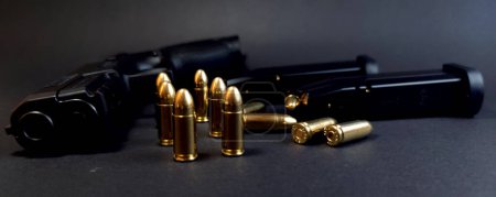 Photo for Gun and cartridges on a dark background, close-up of cartridges, photo - Royalty Free Image