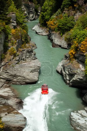 Téléchargez les photos : Promenade en bateau à réaction à grande vitesse sur la rivière Shotover de Queenstown à Queenstown, Nouvelle-Zélande. Queenstown est un endroit populaire pour pratiquer des sports à risque - en image libre de droit