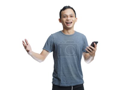 Foto de Joven sonriente guapo asiático hombre en traje casual utilizando el teléfono móvil con amplio brazo abierto aislado fondo del estudio - Imagen libre de derechos