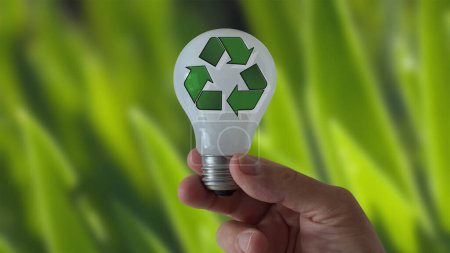 Photo for A hand with a lightbulb featuring the recycling symbol - Royalty Free Image