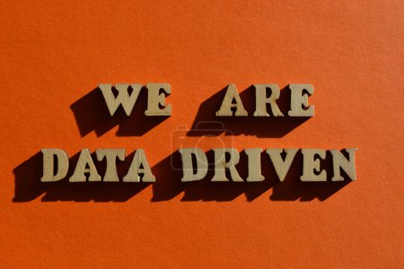 Photo for We Are Data Driven, words in wooden alphabet letters isolated on orange background - Royalty Free Image