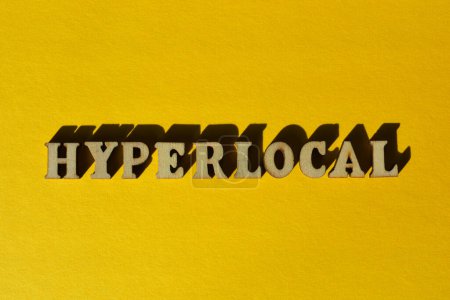 Téléchargez les photos : Hyperlocal, word in wooden alphabet letter isolated on yellow background - en image libre de droit