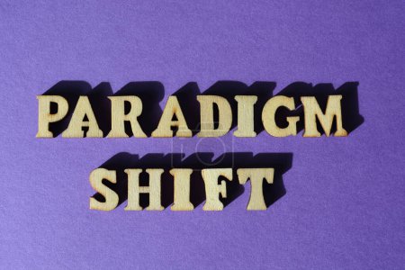 Foto de Paradigm Shift, words in wooden alphabet letters isolated on purple background as banner headline - Imagen libre de derechos