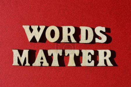 Words Matter, in wooden alphabet letters isolated on red background