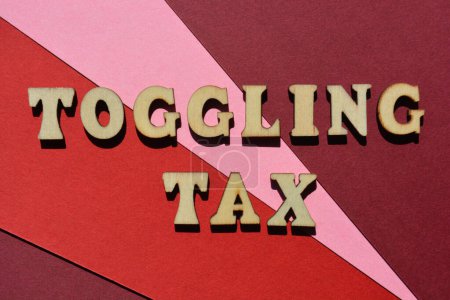 Photo for Toggling Tax, words in wooden alphabet letters isolated on red background. Buzzword refers to the equated cost per time spent to toggle between applications - Royalty Free Image