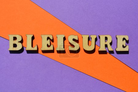 Photo for Bleisure, word in wooden alphabet letters isolated on colourful background. Buzzword created by combining the words business and leisure - Royalty Free Image