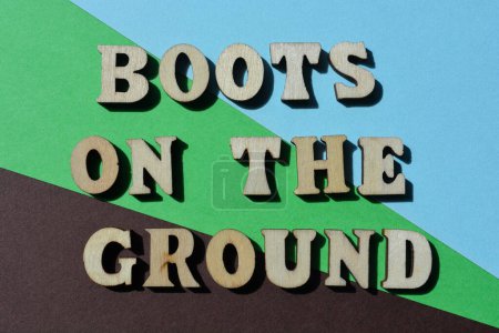 Photo for Boots on the Ground, words in wooden alphabet letters isolated on background as banner headline - Royalty Free Image