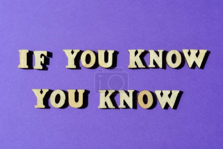 Photo for If You Know You Know, words in wooden alphabet letters isolated on purple background - Royalty Free Image