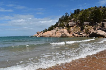 Photo for Beach scene at Alma Bay with granite rocks and Hoop Pines in the background, typical of the coast on Magnetic Island, Queensland, Australia - Royalty Free Image