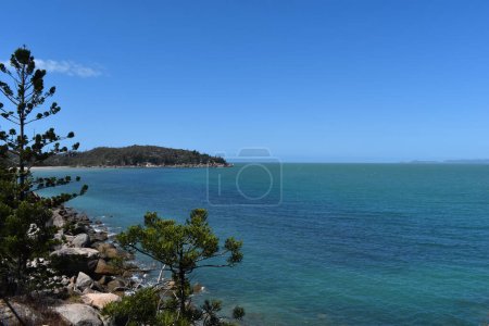 Photo for View over Geoffrey Bay with granite rocks and hoop pines on the Gabul Way Coastal Walkway from Nelly Bay, Magnetic Island, Queensland, Australia - Royalty Free Image