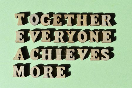 Téléchargez les photos : L'acronyme TEAM pour Together Everyone Achieves More in wooden alphabet letters isolated on green background - en image libre de droit