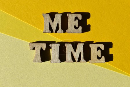 Me Time, words in wooden alphabet letters isolated on yellow background as banner headline