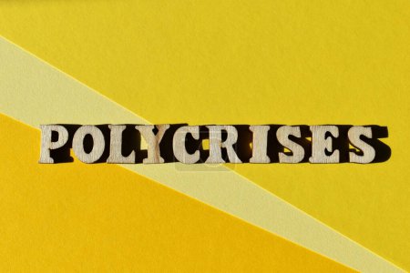 Photo for Polycrises, word in wooden alphabet letters isolated on yellow background as banner headline with copy space - Royalty Free Image