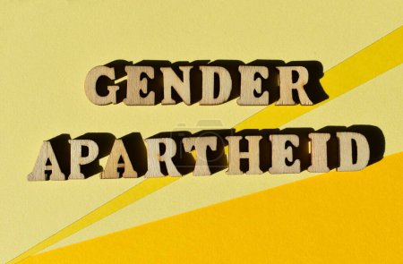 Photo for Gender Apartheid, words in wooden alphabet letters isolated on yellow background as banner headline - Royalty Free Image