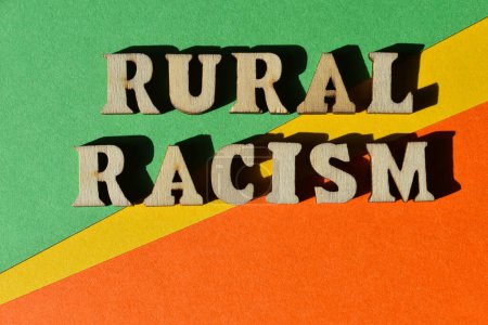 Foto de Racismo rural, palabras en letras de alfabeto de madera aisladas en el fondo como titular de la bandera - Imagen libre de derechos