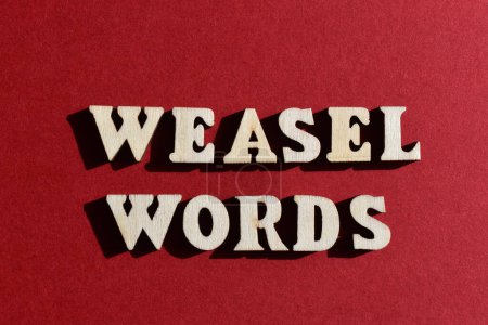Photo for Weasel Words, phrase in wooden alphabet letters isolated on red background - Royalty Free Image