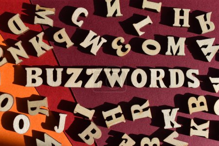 Photo for Buzzwords, word in wooden alphabet letters surrounded by random letters on background as banner headline - Royalty Free Image