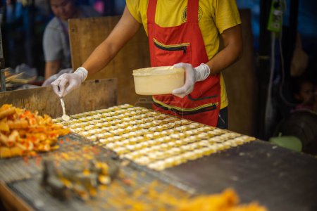 Photo for Street food next to the road, walking street" typically refers to a lively and popular culinary scene where vendors and food stalls set up along a street or pedestrian-only walkway, offering a wide variety of local and international dishes to pedestr - Royalty Free Image