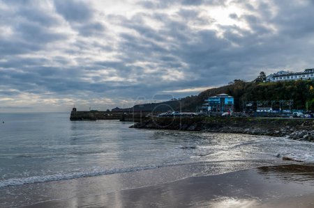 Photo for A view from the beach towards the harbour in Saundersfoot, Wales in winter - Royalty Free Image