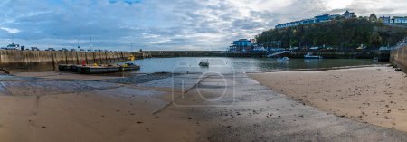 Photo for A panorama view down the slipway into the harbour at high tide in Saundersfoot, Wales in winter - Royalty Free Image