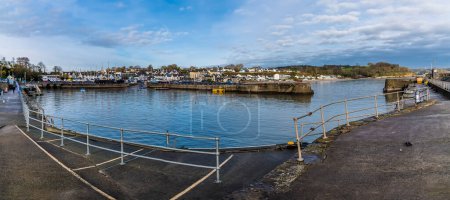 Photo for A panorama view across the harbour at high tide in Saundersfoot, Wales in winter - Royalty Free Image