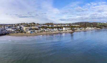 Photo for An aerial view along the coastline of the village of Saundersfoot, Wales in winter - Royalty Free Image