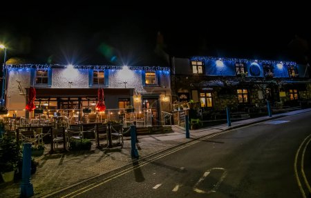 Photo for A view up Wogan Terrace at night in Saundersfoot village in Wales in winter - Royalty Free Image