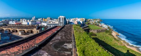 Photo for A view over the upper battlements of the Castle of San Cristobal along the coast in San Juan, Puerto Rico on a bright sunny day - Royalty Free Image