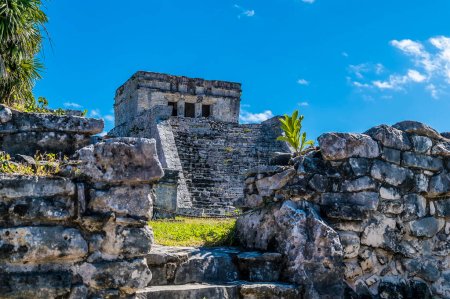 A view towards the castle ruins at the Mayan settlement of Tulum, Mexico on a sunny day