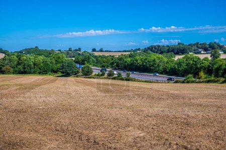 Photo for A view down a field towards the M40 motorway in Oxfordshire, UK in summertime - Royalty Free Image