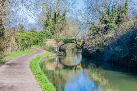 A view down the Grand Union canal towards a bridge near Market Harborough, UK on a bright Winter's day