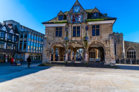 A view across the cathedral square towards the Guildhall and shops in Peterborough, UK on a bright sunny day