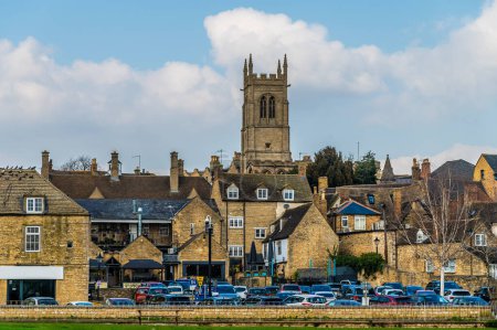 A view across the River Welland towards Saints John the Baptist Church in the town of Stamford, Lincolnshire, UK in winter