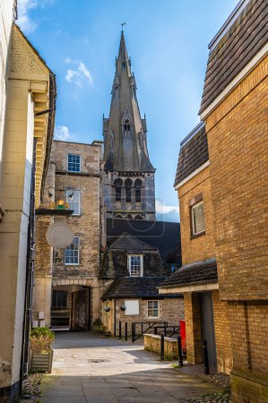 A view down a backstreet towards Saint Marys Church in Stamford, Lincolnshire, UK in springtime