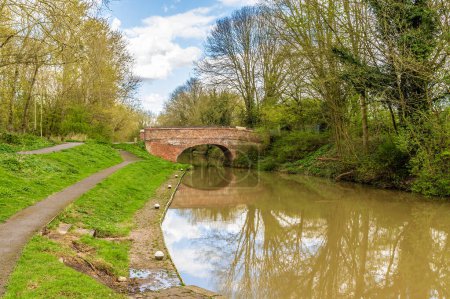 A view from the Aylestone Mill lock towards a bridge over the Grand Union Canal in Aylestone Meadows, Leicester, UK in Springtime