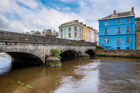 Photo for A view along a road bridge over the River Cleddau in the centre of Haverfordwest, Pembrokeshire, Wales on a spring day - Royalty Free Image